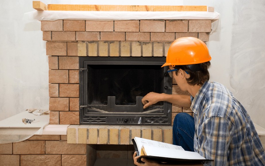 Technician inspecting fireplace